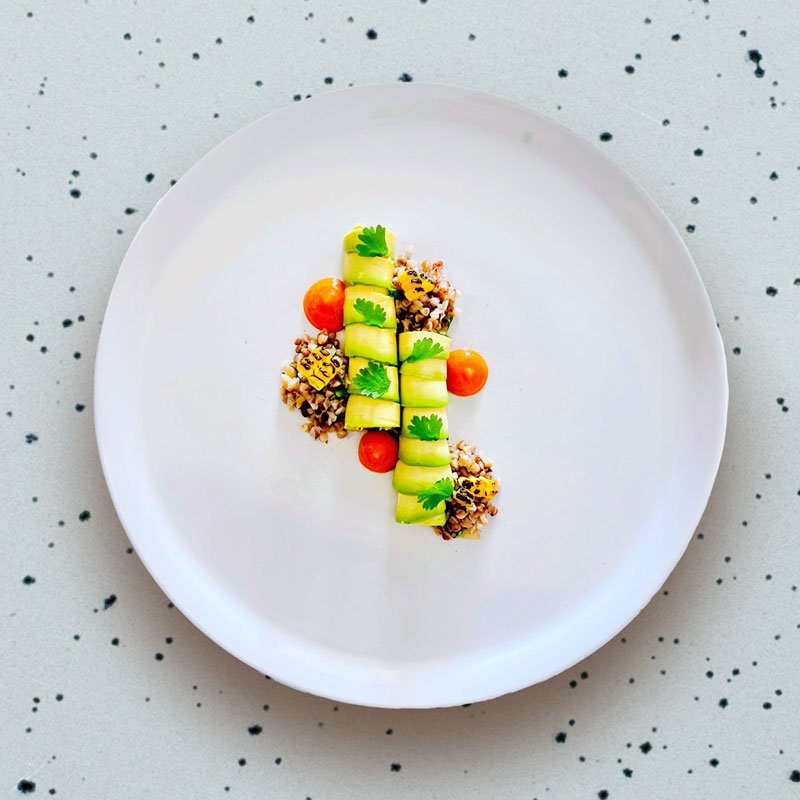 Image displaying a vibrant dish by Signature Chef Cy, blending fresh, colorful ingredients with meticulous presentation, inviting diners to savor the harmony of flavors and artistic plating.