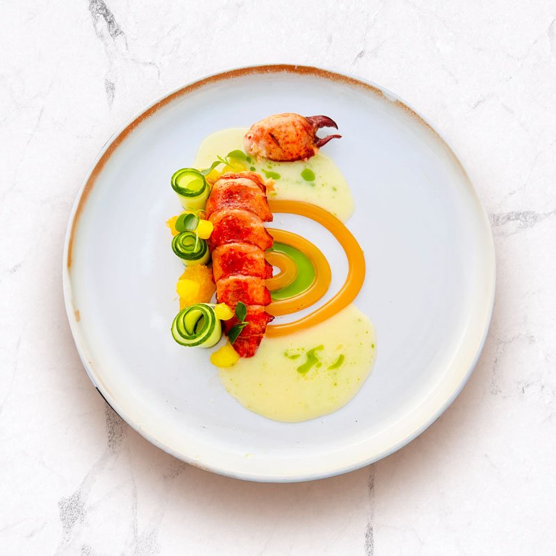 Image displaying a culinary creation by Signature Chef Cy, presenting a blend of savory dishes with meticulous attention to detail, inviting diners to savor the array of flavors and artistic presentation.
