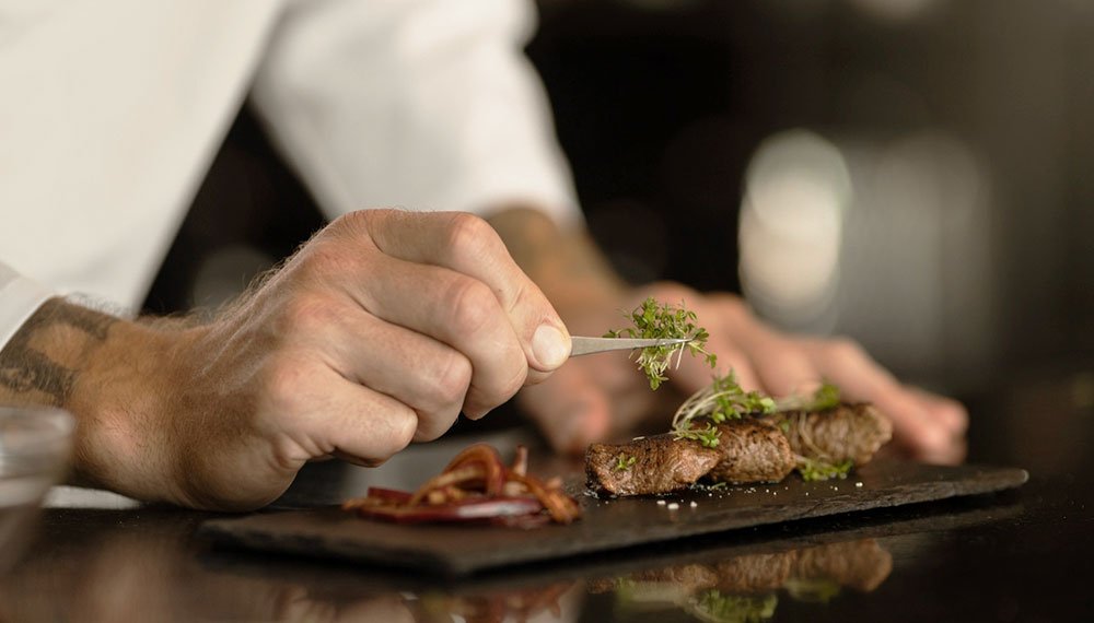 An innovative culinary presentation by Signature Chef Cy, showcasing a meticulously composed dish. Vibrant, artfully arranged ingredients merge in a contemporary display, defining the forefront of gastronomic trends. The dish features a harmonious blend of colors, textures, and modern culinary elements, inviting diners to explore the innovative landscape of contemporary cuisine.